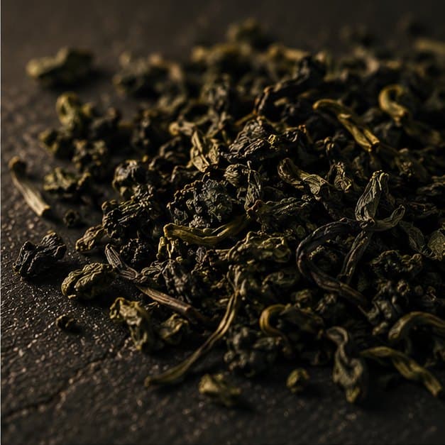 Pan-dried green, curled into irregular pellets, matte olive.